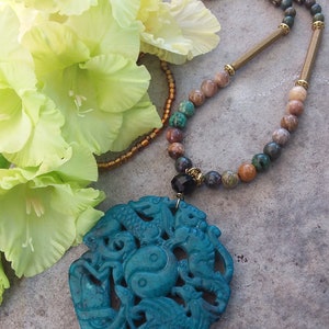 Necklace with stones and pendant with the symbol of the four animals, large amulet