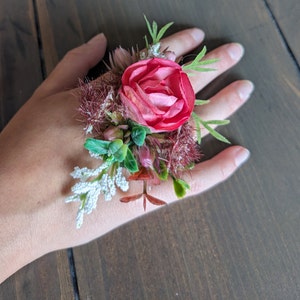 Rose pink, burg accents, white, green; Corsage ring or wristlet; artficial