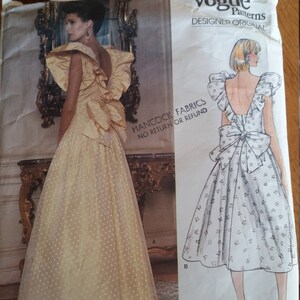 May include: Vintage Vogue sewing pattern for a dress with a bow in the back. The pattern is for a Bellville Sassoon design and is number 1355.