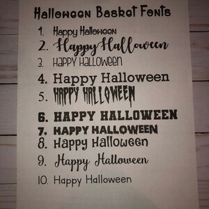 May include: A list of ten different font styles for the phrase "Happy Halloween" in black text on a white background. The fonts range from simple to elaborate.