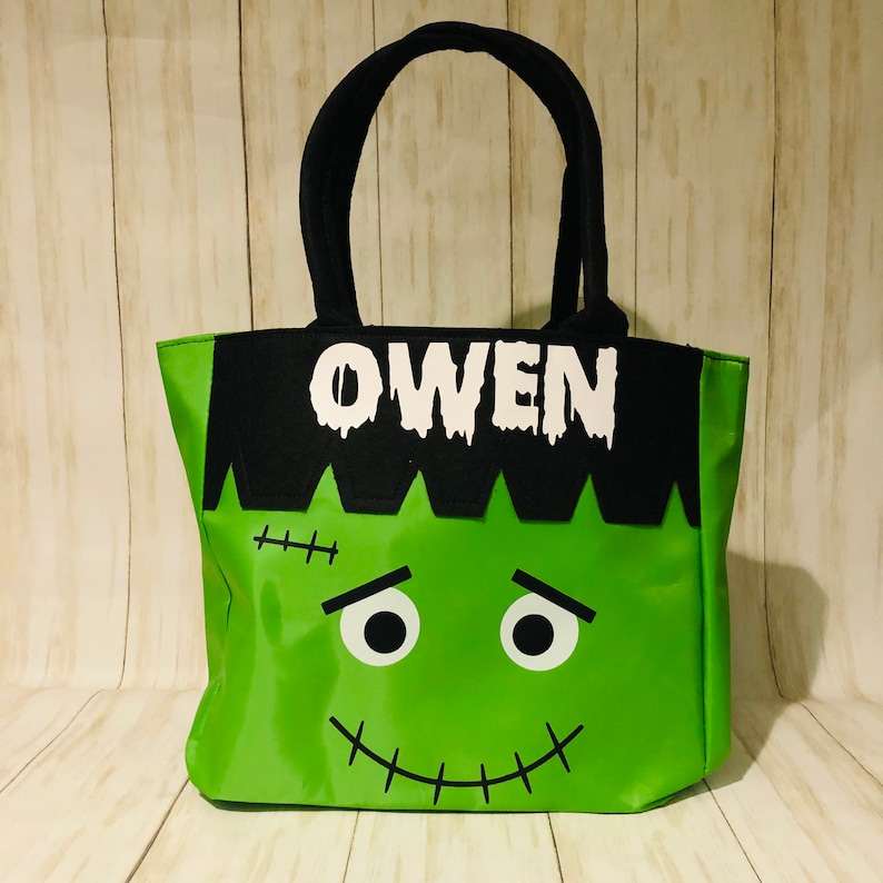 May include: Green and black Halloween trick-or-treat tote bag with a Frankenstein face and the name Owen.