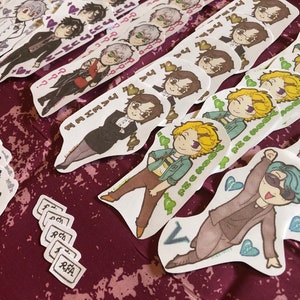 May include: A collection of white stickers featuring cartoon characters with different expressions. The stickers are arranged in rows and columns on a burgundy surface. Some of the stickers have text on them, including "I love you" and "The RFA".
