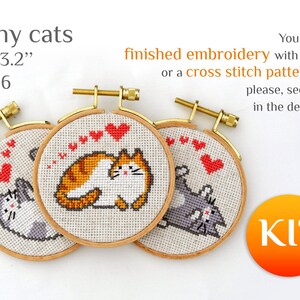 May include: Three small embroidery hoops with cat designs. Each hoop, approximately 3.2 inches (8.1 cm) in diameter, features a different cat in a cross-stitch pattern, with red heart accents. The text "Funny cats" is at the top.