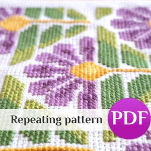 May include: A cross-stitch embroidery featuring a repeating floral pattern with purple petals, yellow centers, and green leaves on a white fabric grid. A purple circular badge with the white text PDF is overlaid on the lower right section.