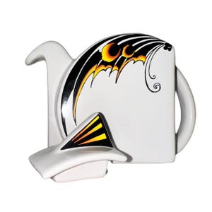 May include: White ceramic teapot with a black, orange and yellow geometric design. The teapot has a separate lid and a spout.