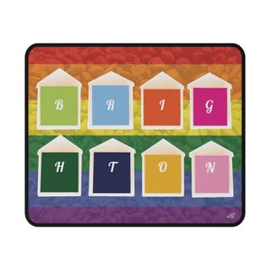 May include: A rectangular mousepad with a rainbow and pebble design. Eight colourful house-shaped designs spell "BRIGHTON", each with a different letter. The mousepad has a black border.