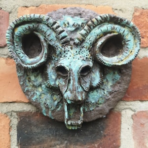 Satyr&#39;s head (or as my wife calls it, a Sheep&#39;s head). A cold cast fantasy gargoyle that can be used as a garden or wall plague.
