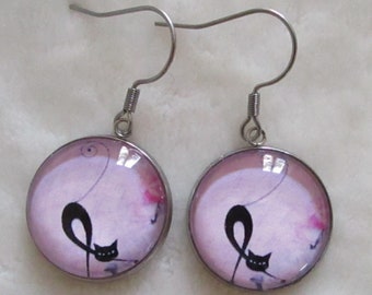 cat earrings on pink background