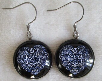 white heart earrings on black background