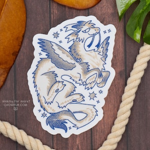 May include: A sticker featuring a stylized illustration of a mythical creature with wings, a long tail, and a pointed snout. The design uses blue and tan colors, with star accents and the text "looking for more? chowfur.com".