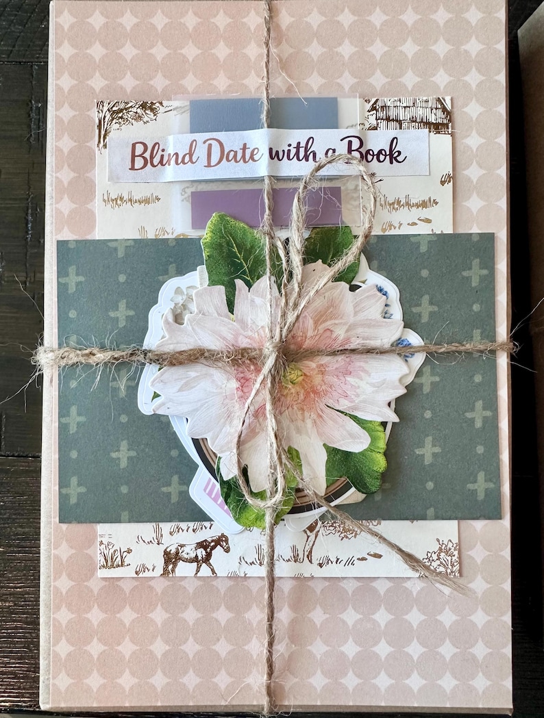 May include: A wrapped book with a decorative flower and twine. The book is wrapped in patterned paper with the text "Blind Date with a Book" on a label. A sticker of a horse is visible.