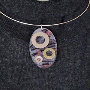 Oval resin and bolts pendant