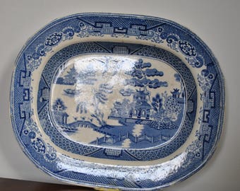 Antique Victorian Willow pattern ironstone dish from the mid 19th century.
