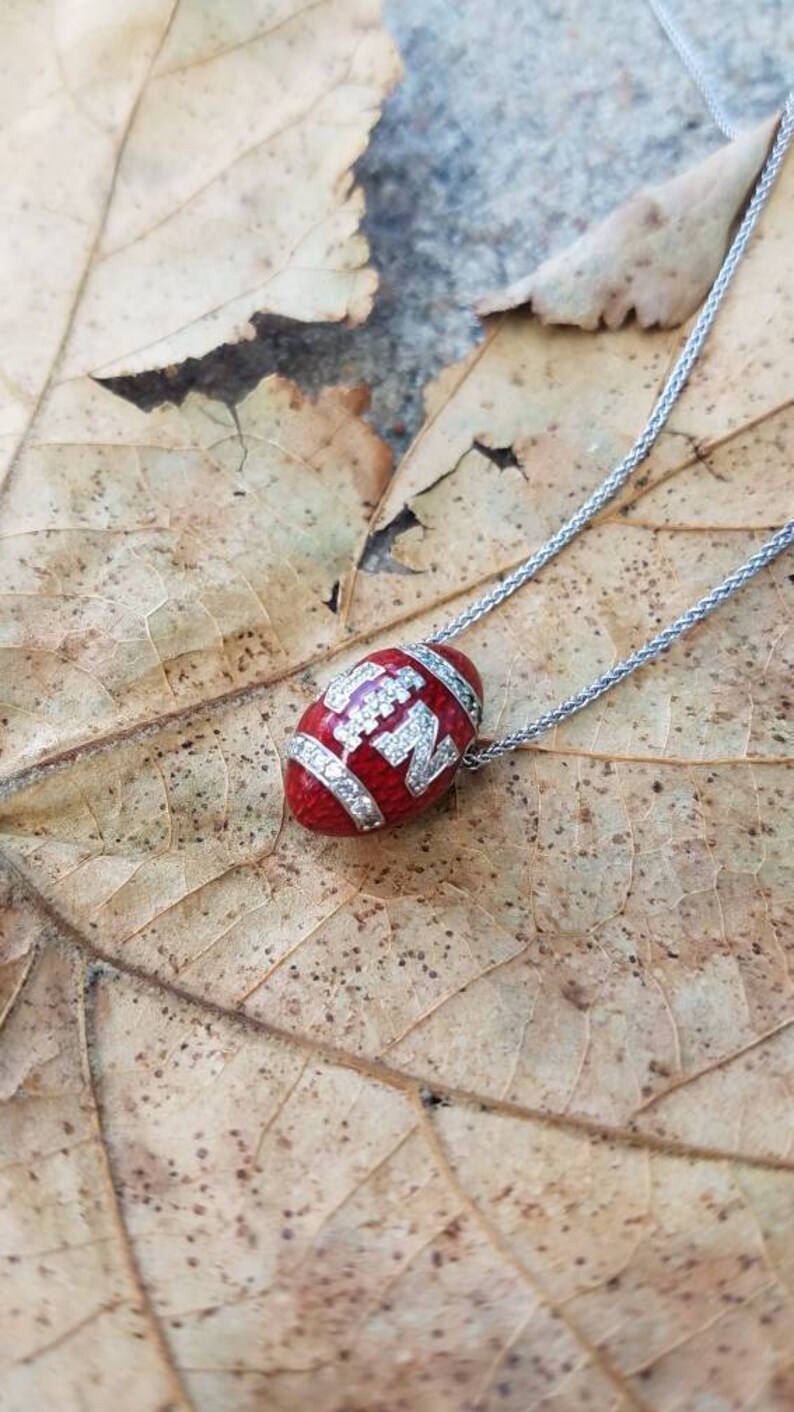 Nebraska Huskers White Gold and Diamond Football Pendant image 1