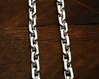 May include: A silver chain necklace with a box chain design. The chain is made of metal and has a polished finish.