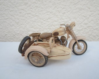 Wooden miniature of a sidecar motorcycle equipped with a V-twin engine.