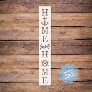 May include: White wooden stencil with the words "Home Sweet Home" and nautical symbols, including an anchor and a compass. The stencil is labeled "Reusable Stencils".