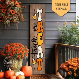 May include: A tall, rectangular wooden sign featuring the vertical text 'trick or TREAT' in a stylized, retro font. The letters are colored in alternating white and orange. Two candy corn illustrations are positioned within the text design.