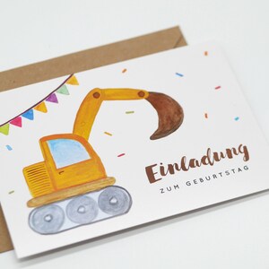 May include: A yellow digger with a brown scoop is on a white card with colourful flags and confetti. The card says "Einladung zum Geburtstag" which is German for "Invitation to Birthday".