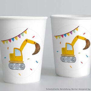 May include: Two white paper cups featuring a yellow excavator design. The excavator is on a white circle with colourful flags and confetti.