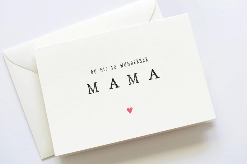 May include: A white card with the text "Du bis so wunderbar MAMA" and a small pink heart.