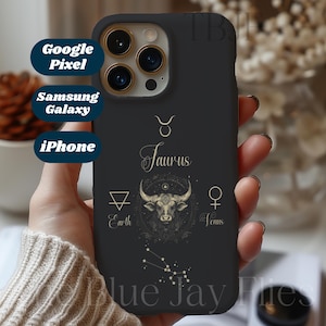 May include: Black phone case with a gold Taurus zodiac sign, a bull, and the words "Taurus", "Earth", and "Venus".