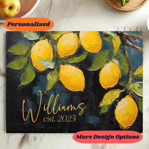 May include: A canvas print featuring a vibrant lemon branch with bright yellow lemons and green leaves against a dark blue background. The name "Williams" and the year "est. 2025" are written in gold script.