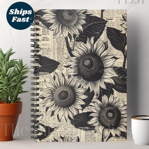Puede incluir: Una libreta de espiral en blanco y negro con un fondo de periódico vintage y un diseño de girasol en blanco y negro.