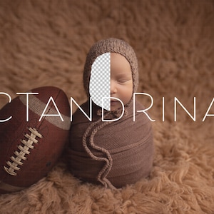 May include: A newborn baby swaddled in a brown fabric with a brown knit hat. The baby is sleeping with its eyes closed. A brown and white football is in the foreground. The text "CTANDRINA" is written in white letters on a brown background.
