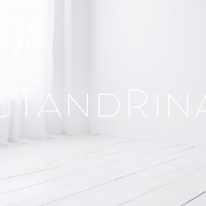 May include: A white room with a white wooden floor and a white curtain in the background. The word "CTANDRINA" is written in white text on the wall.