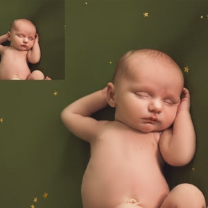 May include: A newborn baby sleeping on a green background with gold stars. The baby is lying on its back with its arms crossed over its chest and its head resting on its arm.