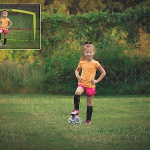 May include: A young person wearing a yellow shirt and pink shorts stands on a soccer field with a soccer ball at their feet. The person is looking at the camera and has their hand on their hip.