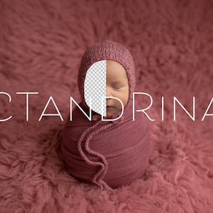 May include: A newborn baby wrapped in a pink swaddle and wearing a pink knitted hat. The baby's face is partially visible and the baby's eyes are closed. The baby is lying on a pink fuzzy surface. The text "CTANDRINA" is visible in the image.