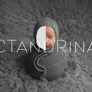 May include: A newborn baby wrapped in a gray knitted blanket, wearing a gray knitted hat. The baby's face is partially visible, with closed eyes. The text "CTANDRINA" is written in white letters on a gray background.