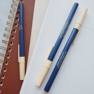 May include: Three blue pens with white caps. The pens have the text "GO, THEREFORE, AND MAKE DISCIPLES... BAPTIZING THEM." printed on them.