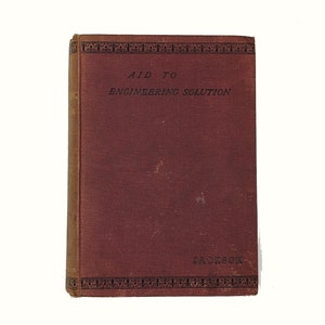 May include: A burgundy book with a black decorative border and the title "Aid to Engineering Solution" by Jackson.
