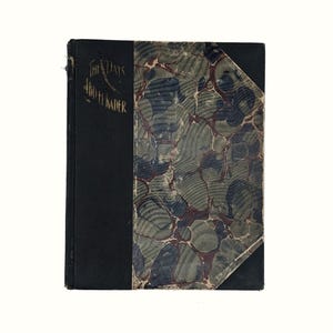 May include: A black hardcover book with a marbled paper cover. The title "The Days of the Kaiser" is printed in gold on the spine.