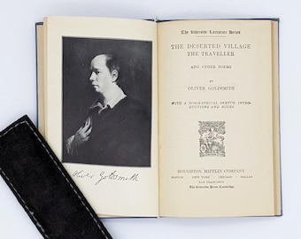 May include: An open book with a black and white portrait of Oliver Goldsmith on the left page. The right page has the title "The Deserted Village The Traveller and Other Poems" by Oliver Goldsmith. The book is published by Houghton Mifflin Company.