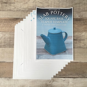May include: A stack of white paper and a printed guide for slab pottery. The guide features a blue square-based teapot with a lid and handle. The text on the guide reads "SLAB POTTERY SQUARE BASE TEAPOT TEMPLATE & STEP-BY-STEP VIDEO GUIDE."