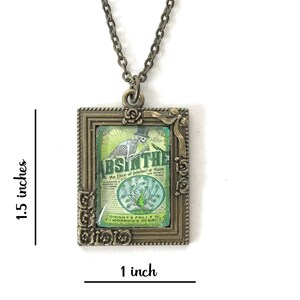 May include: A bronze pendant necklace with a square frame featuring a vintage-style illustration of a skeleton holding a bottle of absinthe. The illustration is surrounded by a decorative floral border. The pendant measures 1 inch by 1.5 inches.