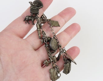 Old west theme etc. dark original patina sterling silver 16 charm braclet