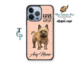 Può includere: Una custodia per telefono rosa e nera con un'illustrazione di un adorabile Cairn Terrier e il testo "LOVE IS A FOUR LEGGED WORD". La custodia è personalizzata con il testo "Any Name".