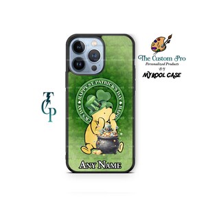 May include: A green and black phone case with a cartoon bear wearing a green hat and holding a pot of gold. The text "Happy St. Patrick's Day" is in a circle around the bear. The case has a space for a name at the bottom.