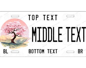 Può includere: Targa bianca con un'illustrazione di un albero di fiori di ciliegio davanti a un sole rosa. La targa riporta le scritte "TOP TEXT", "MIDDLE TEXT" e "BOTTOM TEXT" in nero.