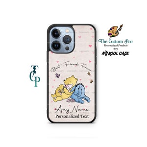 May include: A pink and white phone case with a Winnie the Pooh and Piglet illustration. The case features the text "Best Friends Forever" and a space for a personalized name and text.