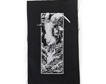 May include: A black and white embroidered patch featuring a goat's head with horns, set against a background of flames and a landscape.