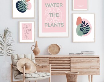 May include: Four framed prints in a pink and green colour scheme. The prints feature a line drawing of a person reading a book, a leafy plant with abstract shapes, a leafy plant with the text "WATER THE PLANTS", and a quote that reads "DON'T READ THE NEXT SENTENCE".