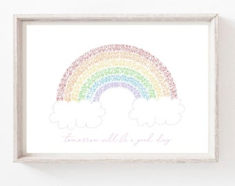 May include: A white framed print featuring a rainbow made of hearts in red, orange, yellow, green, blue, indigo, and violet. The rainbow is above two white clouds with dotted outlines. The text "tomorrow will be a good day" is written in pink below the clouds.