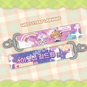 May include: Two wrist strap lanyards featuring cartoon characters and text. One is pink with a rainbow, the other purple with Korean text. Both have silver clasps and the text "WRIST STRAP LANYARD".