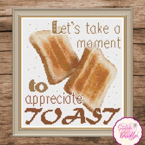 May include: A cross-stitch pattern featuring two slices of golden-brown toast centered on a white grid background. The text reads, Let's take a moment to appreciate TOAST, rendered in brown block lettering. A small logo is in the corner.